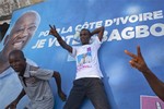 Supporters of Laurent Gbagbo celebrate ahead an electoral board of Gbagbo in the streets of Adjame neighborhood, in Abidjan, Ivory Coast, Friday, Dec. 3, 2010, after the constitutional council declared incumbent President Laurent Gbagbo the winner a day after the election chief handed victory to the opposition.