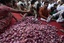 People try to grab onions being sold by a political party at cheap rates as a mark of protest against the rising prices in Mumbai, India, Sunday, Jan. 9, 2011.