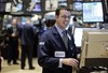 Specialist Neil Gallagher smiles as he works on the floor of the New York Stock Exchange Tuesday, Dec. 16, 2008. A surprised Wall Street jumped Tuesday at the Federal Reserve's historic decision to further slash interest rates and pledge broad support to reinflate the troubled economy