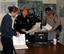 LOS ANGELES, Calif. (March 24, 2003)--Lt. j.g. Vanessa Martin of Marine Safety Office Los Angeles confers with Los Angeles Port Police Sgt. Rosa Reynoso while California Highway Patrol Officer James Ragle observes in the Joint Operation Center in Los Angeles. The Coast Guard along with Customs, Immigration and Naturalization Service, Los Angeles County Sheriff's Office, Port Police, Los Angeles Police Department, Los Angeles Fire Department and California Department opened the Joint Operation Ce