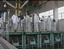 In this image from television, foreign reporters and workers in protective gear are seen at North Korea's main nuclear reactor in Yongbyon, Friday, Feb. 22, 2008.