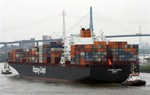 The container ship Colombo Express by German-based shipping company Hapag-Lloyd is escorted by tugboats upon arrival at the port of Hamburg, northern Germany, in this April 29, 2005 file picture.