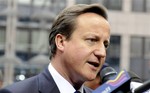 British Prime Minister David Cameron  speaks with the media as he arrives for an EU summit in Brussels on Thursday, Oct. 28, 2010.