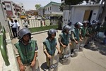 Egyptian policemen stand guard outside Arab Contractors construction company branch in Tamoh, outside Cairo, Tuesday, July 6, 2010 where a disgruntled employee opened fire on his colleagues, killing six and wounding 16 others.