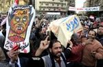 Egyptian anti-Mubarak protesters celebrate during a symbolic funeral for President Hosni Mubarak at Tahrir square in Cairo, Egypt, Sunday, Feb. 6, 2011.