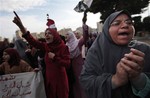 Egyptian anti-government demonstrators chant slogans as they gather in Tahrir Square, the center of anti-government demonstrations, in Cairo, Egypt, Sunday, Feb. 6, 2011.