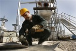 Iranian oil worker Gholam Reza Karimi, works at the oil separator facilities in Azadegan oil field, some 480 miles (800 kilometers) southwest of the capital, Tehran, Iran, Tuesday, April 15, 2008.