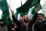 Jordanian opposition protesters shout slogans and carry the Islamic Action Front, IAF, flag during a protest against Jordan's new prime minister Marouf Al Bakhit and in support of the Egyptian people in Amman, Jordan, Friday, Feb. 4, 2011. Hundreds of Jordanians inspired by Egypt's uprising on Friday staged a protest against Jordan's prime minister, installed just days earlier in response to anti-government marches.