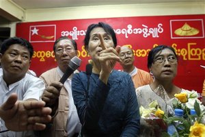 Myanmar's pro-democracy leader Aung San Suu Kyi, center, gestures during her first press conference since she was released from house arrest in Yangon, Myanmar, Sunday, Nov. 14, 2010. Suu Kyi, freed from seven years of house arrest on Saturday, told thousands of wildly cheering supporters Sunday that she would continue to fight for human rights and the rule of law in the military-controlled nation.