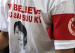 A member of the detained pro-democracy leader Aung San Suu Kyi's National League for Democracy Party wears T-shirt printing with portrait of Suu Kyi as he sits outside the party's headquarters Monday, March. 29, 2010, in Yangon, Myanmar. The party on Monday appeared poised to opt out of the first election in military-ruled Myanmar in two decades. (AP Photo/Khin Maung Win)