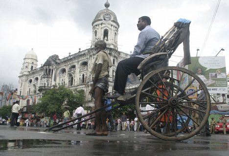 INDIA-DYFI-CHAKKA-JAM A hand rickshawpuller waits with a passenger during DYFI's chakka jam protest against price rise in Kolkata on Tuesday 03 July 2010 in Eastern India City ----- WN/BHASKAR MALLICK