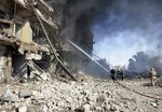 Iraqi firefighters extinguish a fire in a destroyed building after a car bomb attack in Kirkuk, 290 kilometers (180 miles) north of Baghdad, Iraq, Wednesday, Feb. 9, 2011. Car bombs ripped through the oil-rich Iraqi city of Kirkuk  on Wednesday, killing several and wounding scores of people in the heart of a region of long-simmering ethnic tensions.