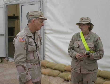 Maj. Vivian Gaz discusses her units operations with the oversight commander of the 377th Theater Support Command, Brig. Gen. Michael Diamond, at the Armys air operations terminal at Ali Al Salem AFB in Kuwait.