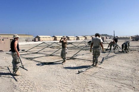 Air Force members assigned to the 355th AEG (Air Expeditionary Group) assemble TEMPER (Tent Extendable Modular Personnel) tent frames at Masirah Air Base, Oman. The tents will be shelters for incoming troops deployed in support of Operation ENDURING FREED