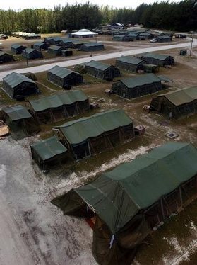 An aerial view of tent-city located inside Camp Justice at Diego Garcia in support of Operation ENDURING FREEDOM. The city is composed of TEMPER (Tents, Extendible, Modular, PERsonnel) tents. Operation ENDURING FREEDOM is in support of the Global War on T