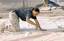 US Air Force (USAF) Staff Sergeant (SSGT) Carmen Simpson from the 332nd Expeditonary Civil Engineering Squadron (ECES), laces up a tent seam for a Temper Tent, during construction of 30 new tents for a C-130 Hercules aircraft squadron area being establish