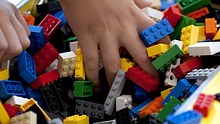 A child plays with Lego blocks