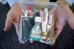 Michael McCarron, director of Community Affairs at San Francisco International Airport, holds a bag of liquids and gel products which will be allowed through security checkpoints under amended rules, Monday, Sept. 25, 2006, during a news conference at the airport in San Francisco. The government is partially lifting its ban against carrying liquids and gels aboard airliners, as long as they are purchased from secure airport stores, and will also permit small, travel-size toiletries brought from home, officials said Monday.