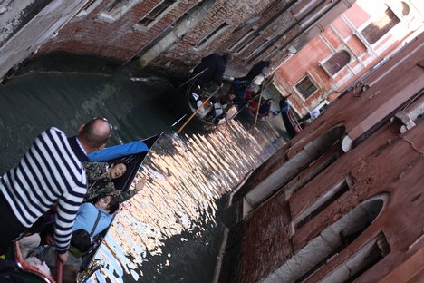 Traffic jam with gondolas the gondola is propelled by a man (the gondolier) who stands facing the bow and rows with a forward stroke, followed by a compensating backward stroke. Contrary to popular belief, the gondola is never poled like a punt as the waters of Venice are too deep.