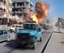 In this image from TV showing the moment that a bomb detonates on a street in Kirkuk, Iraq, on Wednesday Feb. 9, 2011, as security forces and emergency vehicles pass along the main road on their way to attend the scene of another explosion.