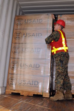 Marine Staff Sgt. Jonathon Thompson inspects cargo from the U.S. Agency for International Development (USAID) and the Marine Corps at Blount Island Command, Jacksonville, Fla.