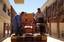 Staff at the Martyr Sadoon Primary School in Kirkuk, Iraq unload furniture from a truck on June 7, 2003. The truck was filled with school furniture that was obtained from funds provided by the United States Agency for International Development (USAID). Me