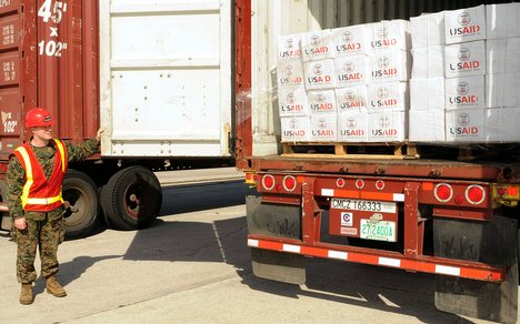 Marine Staff Sgt. Jonathon Thompson inspects cargo from the U.S. Agency for International Development (USAID) and the U.S. Marine Corps at Blount Island Command