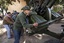 New Libyan rebel recruits from the forces against Libyan leader Moammar Gadhafi push an anti-aircraft gun at a military base in Benghazi, eastern Libya, Tuesday, March 1 , 2011.