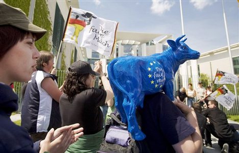 The wives of German dairy farmers protest in front of the chancellery in Berlin, Germany, Sunday, May 17, 2009.