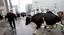 A business man runs from a cow during a demonstration in front of EU headquarters in Brussels, Monday Oct. 5, 2009.