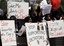 About 150 Bahraini demonstrators calling for a new government protest Monday, March 7, 2011, outside the U.S. Embassy in Manama, Bahrain, with signs urging the United States to support a democracy movement in Bahrain. The small white signs in Arabic read: "Leave Al Khalifa."