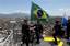 Policemen place a Brazilian flag at a top point of the Complexo do Alemao slum in Rio de Janeiro, Brazil, Sunday, Nov. 28, 2010. Rio's most dangerous slum that was the backbone of the city's biggest drug gang was taken by 2,600 police and soldiers Sunday, an unprecedented accomplishment by authorities in their fight to secure this seaside metropolis that will host the 2016 Olympics.