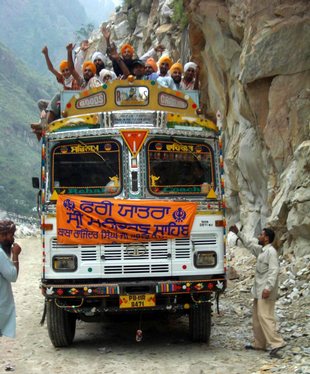 Pilgrims cheering on bus