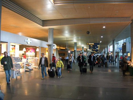 Arrival Passengers hall.The 64 kilometers (40 mi) Gardner mobanen opened the same day as the airport, and runs in a tunnel below the airport facilities. The rail station is built into the airport terminal.