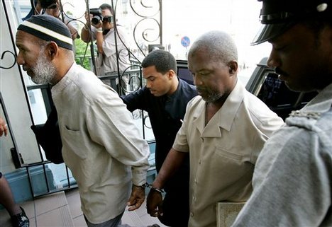 Trinidadian Kareem Ibrahim, 56, left, and Guyanan Abdul Kadir arrive to the Magistrate Court for an extradition hearing in downtown Port-of-Spain, Trinidad, Monday, June 4, 2007.