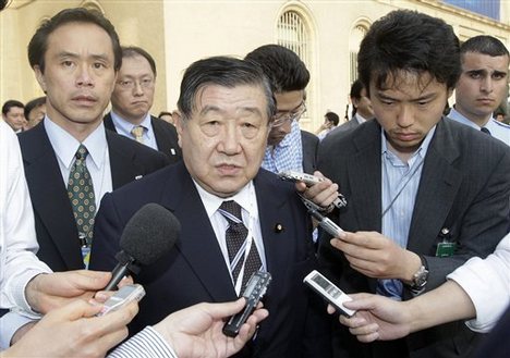 Japan's Agriculture Minister Masatoshi Wakabayashi, flanked by journalists, leaves the WTO after crucial trade talks collapsed, during the World Trade Organisation ministerial summit on trade liberalisation talks, at the World Trade Organization (WTO) headquarters, in Geneva, Switzerland, Tuesday, July 29, 2008.The talks for trade liberation were broke up after nine days of negotiations. New talks may be held in coming autumn, as Diplomates declared this Tuesday ev