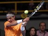 Rafael Nadal, of Spain, returns a shot to Novak Djokovic, of Serbia, during an exhibition match in Bogota, Colombia, Monday, March 21, 2011.