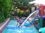 A child practices uphauling a lightweight rig in a swimming pool. The students of windsurfing are the backbone of windsurfing