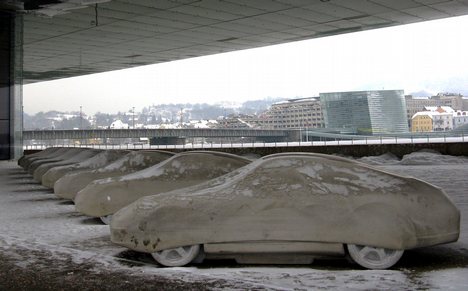 Models of Porsche automobiles, made out of concrete, part of an exhibition, 