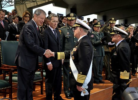 Chief of Naval Operations (CNO) Adm. Gary Roughead, middle, is congratulated by Minister of Defense Gabriel Silva, left, after receiving the Admiral Padilla Naval Order of Merit from Colombian President Alvaro Uribe.