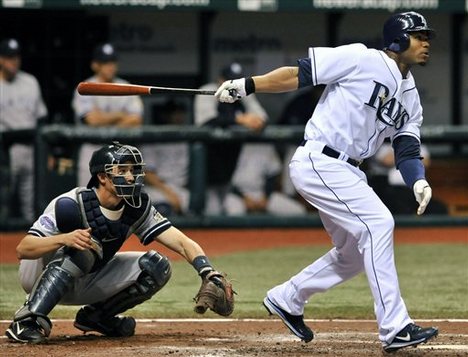 Tampa Bay Rays' Carl Crawford, right, and New York Yankees catcher Chad Moeller watch Crawford's two-run home run off Yankees reliever Billy Traber during the seventh inning of a baseball game Monday, April 14, 2008 in St. Petersburg, Fla.