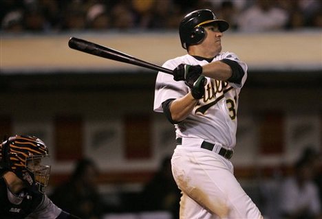 Oakland Athletics' Jack Cust hits a two-run single off of Detroit Tigers' Macay McBride in the sixth inning of a baseball game on Tuesday, July 31, 2007, in Oakland, Calif.