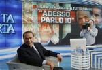 Italian Premier Silvio Berlusconi turns to photographers prior to the recording of the talk show Porta a Porta (Door to door), on state television RAI, in Rome, Tuesday, May 5, 2009.