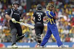 Sri Lanka's fast bowler Lasith Malinga, right, reacts after New Zealand's batsman Scott Styris, left, played a shot off his bowling during the Cricket World Cup semifinal match between Sri Lanka and New Zealand in Colombo, Sri Lanka, Tuesday March 29, 2011.