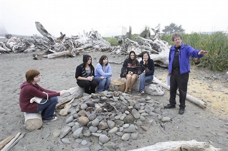 ** ADVANCE FOR SUNDAY, SEPT. 21 ** Visitors listen Friday, Sept. 5, 2008, to Michael Gurling, right, of the Forks, Wash., Chamber of Commerce, talk about the bonfire location on a beach in LaPush, Wash., that is portrayed as the place where Bella Swan, the main character in author Stephenie Meyer's vampire-themed 