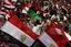 An Egyptian protester holds a Libyan flag as he attends a rally in the Tahrir square in Cairo, Egypt, Friday, April 8, 2011.