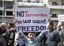 In this citizen journalism image made on a mobile phone and acquired by the AP, a Syrian boy carries a banner during an anti-government demonstration in the coastal city of Banias, Syria, Friday, April 22, 2011.