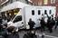 Members of the media gather around a prison van as it leaves the rear entrance of Westminster Magistrates Court in London, Tuesday, Dec. 7, 2010, where WikiLeaks founder Julian Assange was denied bail after appearing on an extradition warrant