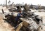 A Libyan rebel fighter climbs on a destroyed government armored vehicle in the besieged city of Misrata, the main rebel holdout in Gadhafi's territory, Friday, April 22, 2011.