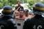 French itinerant people face riot policemen during the closing of their camp in Langlet, south western France, Friday Aug. 13, 2010.